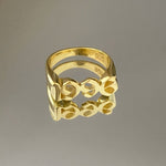 A gold-colored metal ring with a geometric pattern, featuring the inscription '925' on the inside.