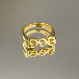 A gold-colored metal ring with a geometric pattern, featuring the inscription '925' on the inside.