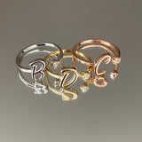 Custom initial ring in 925 sterling silver – accented with delicate stones